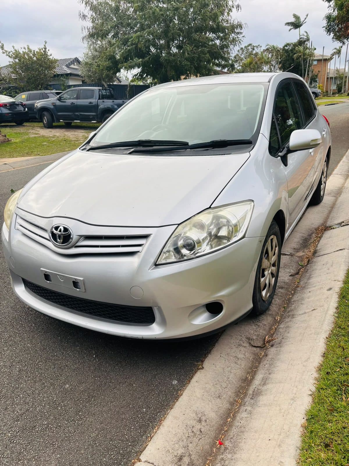 Silver 2012 Toyota Corolla hatchback parked on a residential street, photo 2