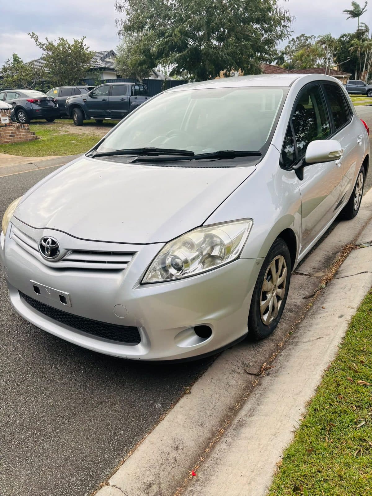 Silver 2012 Toyota Corolla hatchback parked on a residential street, photo 6